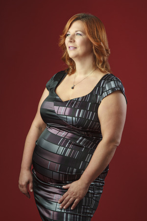 plus size fashion model against a red backgroundの写真素材