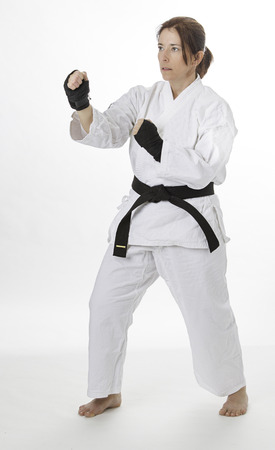 woman in her fortie, wearing black hand protector and a martial art uniformの写真素材