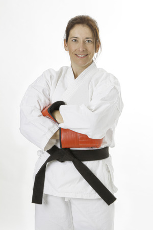 woman in her fortie, wearing red boxing gloves with arms crossの写真素材