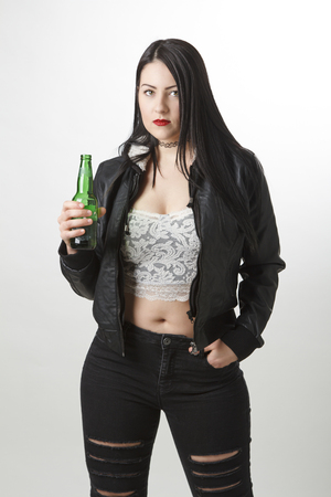 twenty something girl holding a green bottle of beerの写真素材