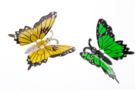 yellow and green toy butterfly made of metalの写真素材