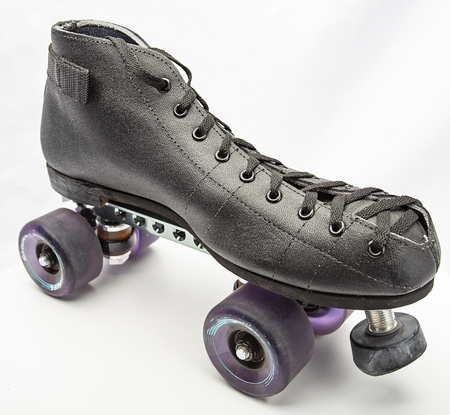 Black boot roller skate with purple wheelsの写真素材