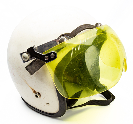 Old white snowmobile helmet with yellow visorの写真素材
