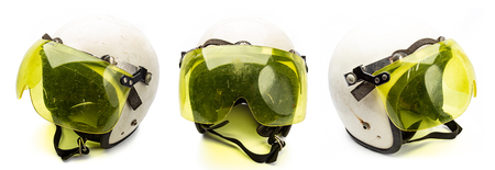 Old white bike helmet with yellow visorの写真素材