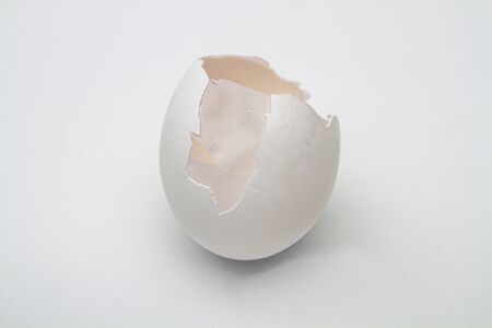 cracked egg with part of the shell brolen showing the inner skinの写真素材