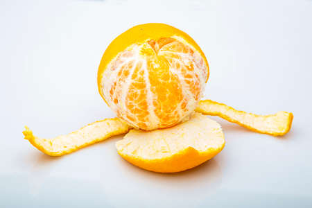 Half peeled clementine against a white backgroundの写真素材