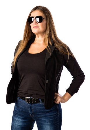 Isolated portrait of a forty year old woman, wearing a sport jacket and dark sunglasses with a tough expressionの写真素材