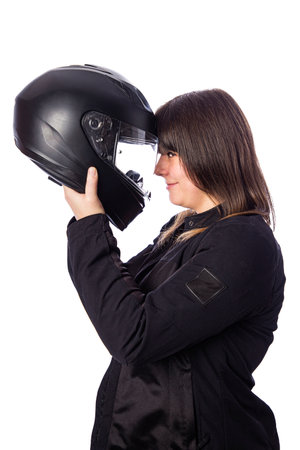 Forty year old woman, wearing  a motocycle jacket, holding a motocycle helmet to her head, isolated on a white backgroindの写真素材