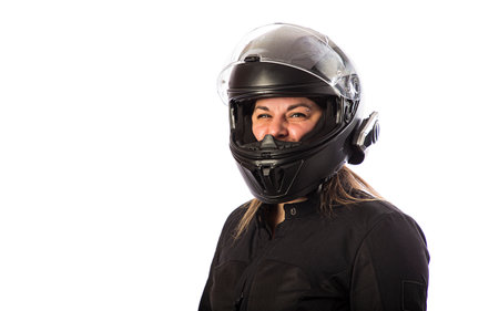 Forty year old woman, wearing motocycle clothing, with helmet and visor up, isolated on a white backgroundの写真素材