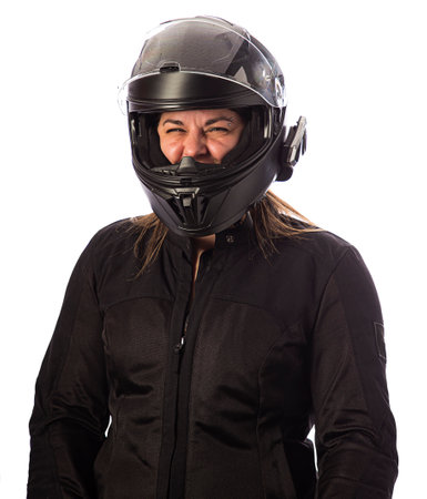 Forty something woman, wearing a motocycle jacket and helmet, isolated on a white backgroundの写真素材