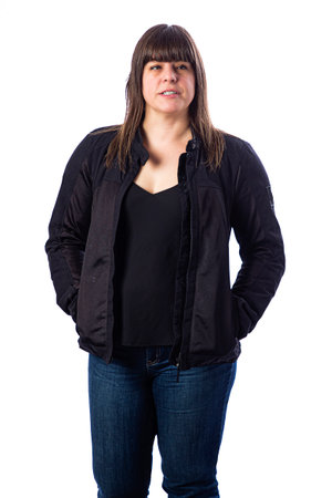 Forty something woman wearing a black motocycle coat against a white backgroundの写真素材