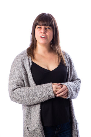 Forty something woman wearing a grey sweater and black top against a white backgroundの写真素材