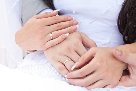 Hands of a newly-married couple with ringsの写真素材