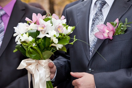 Wedding bouquet in hands of the groomの写真素材