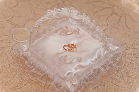 Wedding rings on a small pillowの写真素材