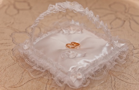 Wedding rings on a small pillowの写真素材