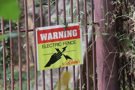 Sign,  in a zoo at Thailand,  tell to tourist are careful.