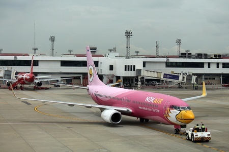 BANGKOK, THAILAND â€“ DECEMBER 22, 2018:  Be airplane picture stops on the ground and officer...