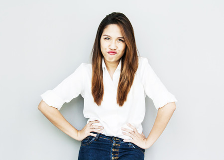 potrait Asian lady mini smile in casual suite White Shirt and blue jeansの写真素材