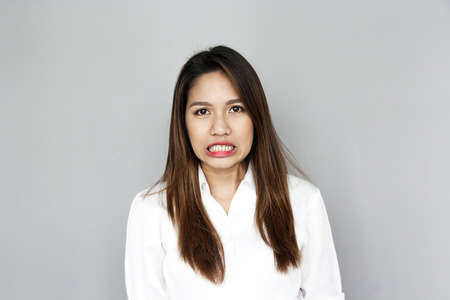 potrait Asian lady mini smile in casual suite White Shirt and blue jeansの写真素材