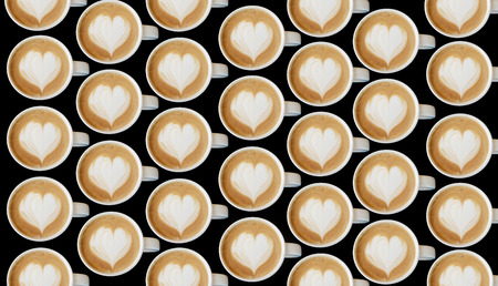 Cup of art cappuccino coffee heart symbol on top view