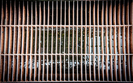 close up dirty and old aligned iron manhole coverの写真素材