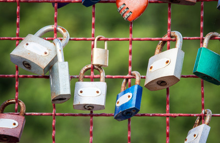 close up of locks at steel grill wallの写真素材