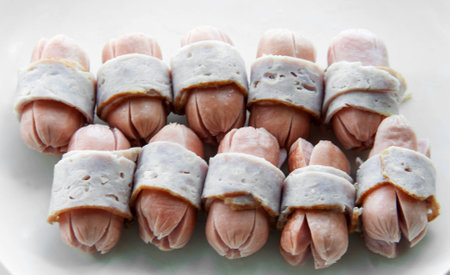 close up boiled bacon wrapped sausageson isolateの写真素材
