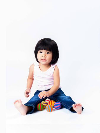 portrait short of asian girl playing color ball in isololateの写真素材