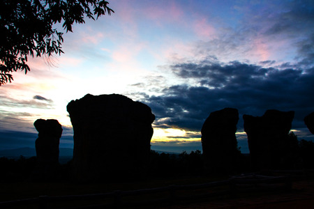 silhouette stone head in sunset