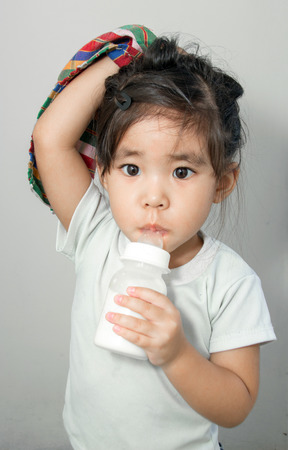 asian girl addict her textile and milk bottleの写真素材