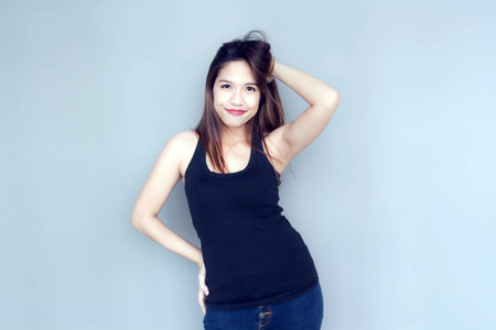 asian lady funny action with black vest and jeansの写真素材