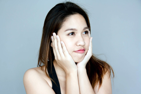 close up Thai asian lady touch her faceの写真素材