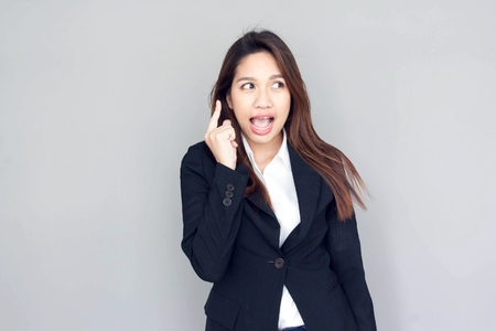 asian girl think action with black suite and blue jeans business conceptの写真素材