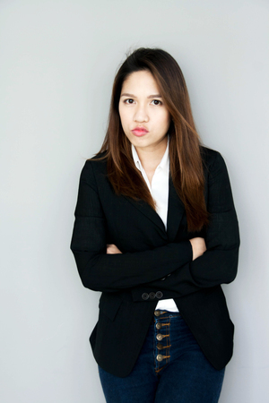 asian girl confuse action with black suite and blue jeans business conceptの写真素材