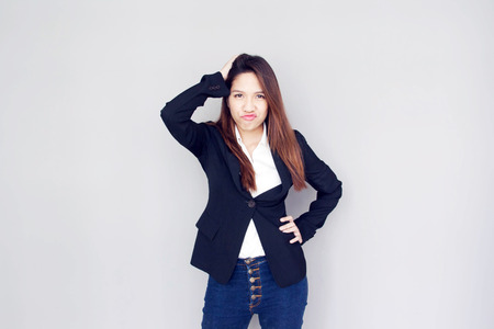 asian girl confuse action with black suite and blue jeans business vintage conceptの写真素材