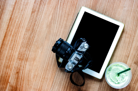 flat shot from top view with camera green tea and tablet on wood tableの写真素材