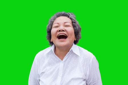 old asian woman laugh on green park backgroundの写真素材