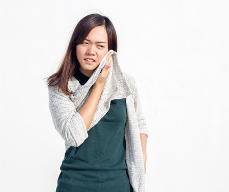 asian Thai lady teen wearing swetter get hot temperature action on white backgroundの写真素材