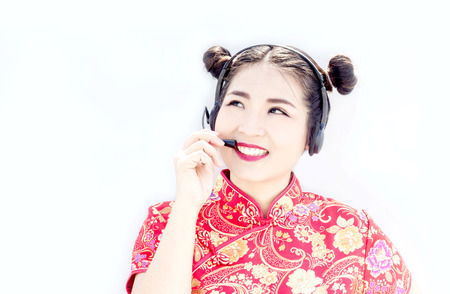 asian chinese call center support with headset and look up to copy space