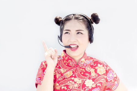 asian chinese call center support with headset and look up to copy space