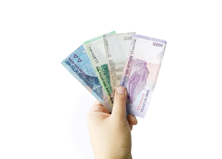 asian hand hold rupiah banknote money on white isolate