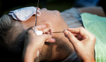 close up ear clean process in barber shop vintage styleの写真素材