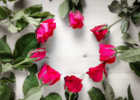 red and pink rose flower on wood table for gift to make relation in valentine day festival and copy space frame conceptの写真素材
