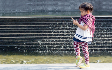 asian girl generation z use addict mobile phone technology and social network on the modern decorationの写真素材