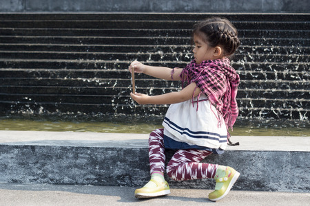 asian girl generation z use addict mobile phone technology and social network on the modern decorationの写真素材