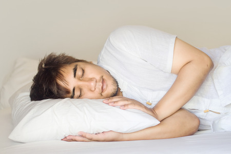 asian man sleep on pilow in sweet dream timeの写真素材