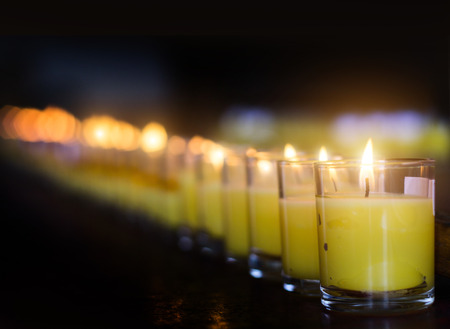 close up burning candel in glass for praying in temple Buddismの写真素材
