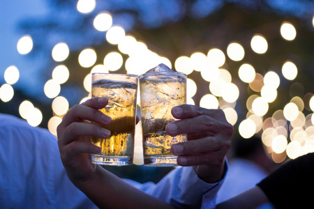 ceremony hand action chese glass of beer in hand in night light shot