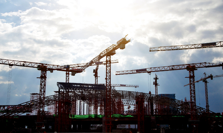 group of crane and stell structure in big construction high building on blue sky show urban city backgroundの写真素材